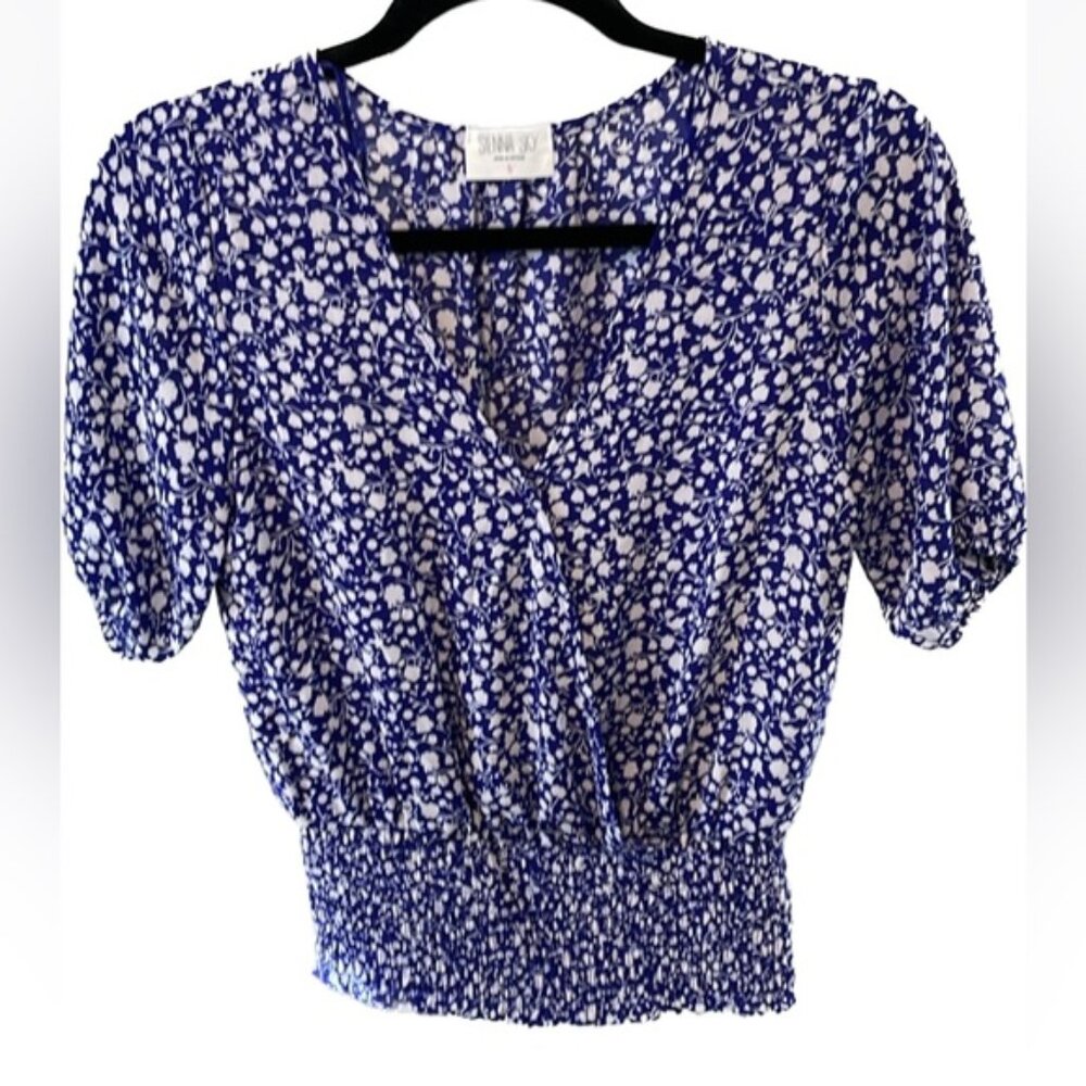 Faux wrap top with a snap closure&smocked at the  waist